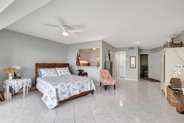 bedroom featuring light tile patterned floors, baseboards, visible vents, and a ceiling fan