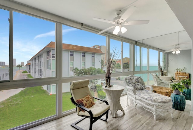 sunroom / solarium with ceiling fan and a healthy amount of sunlight