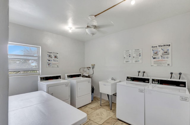 common laundry area featuring stone finish floor, independent washer and dryer, and a ceiling fan