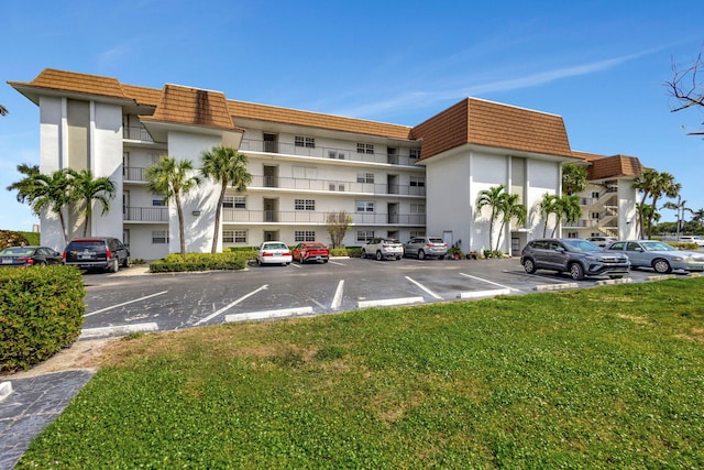2936 Lake Shore Dr Unit 309, Riviera Beach, FL 33404 - view of building exterior featuring uncovered parking