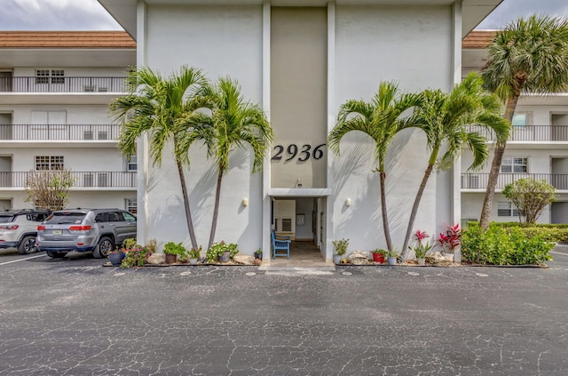 view of property featuring uncovered parking