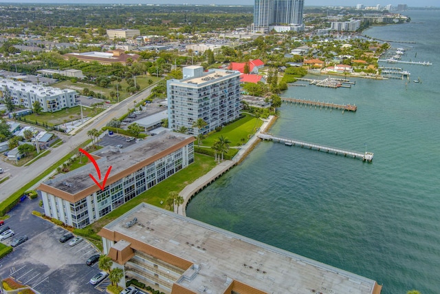 birds eye view of property with a water view and a city view