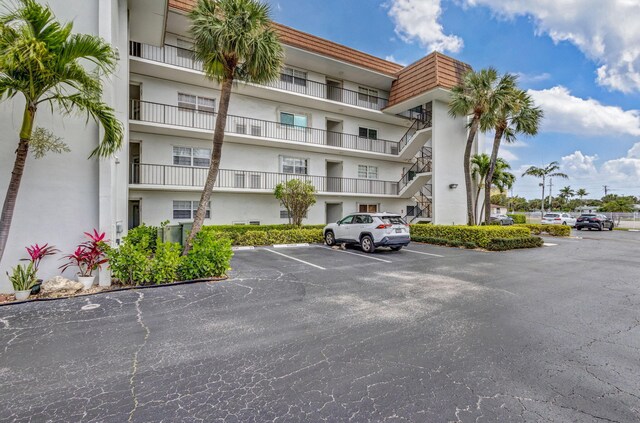 2936 Lake Shore Dr Unit 309, Riviera Beach, FL 33404 - view of building exterior with uncovered parking