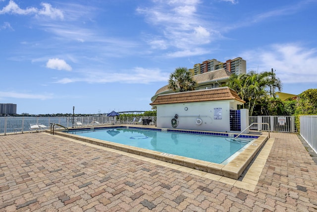 pool featuring a patio area and fence