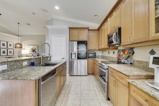 kitchen with appliances with stainless steel finishes, light stone counters, a sink, and ornamental molding