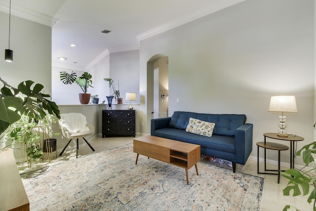 living room featuring baseboards, visible vents, arched walkways, and crown molding