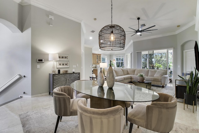 dining room with ornamental molding, arched walkways, and light tile patterned flooring