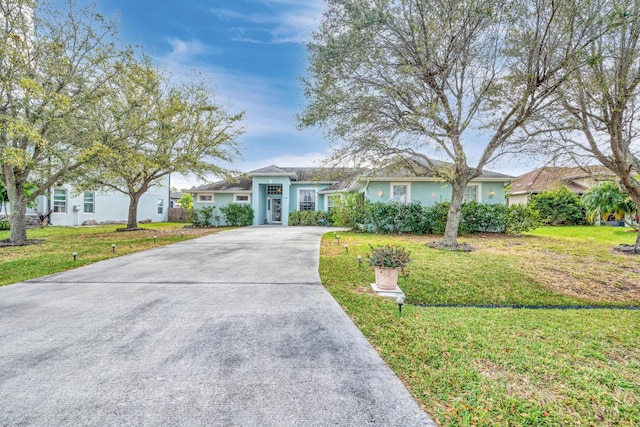 single story home with a front yard and concrete driveway