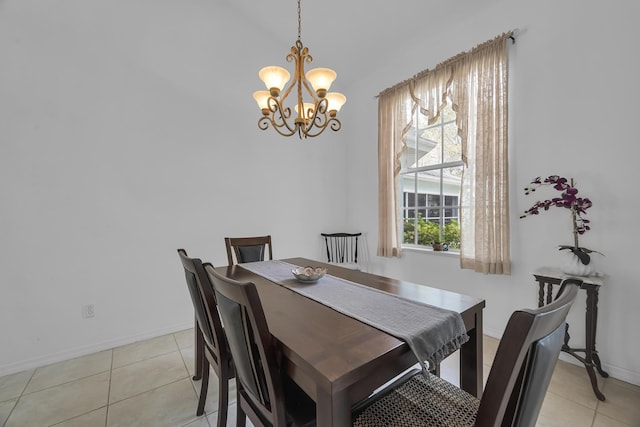 dining space featuring light tile patterned floors, baseboards, and a notable chandelier