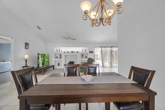 dining space featuring built in features, light tile patterned floors, visible vents, vaulted ceiling, and ceiling fan with notable chandelier