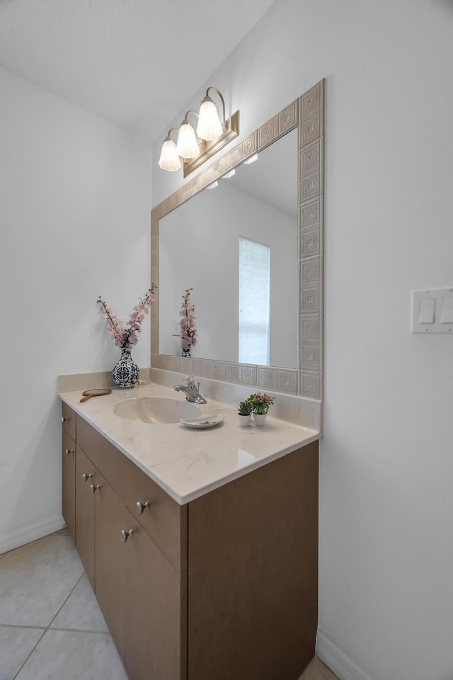 bathroom with tile patterned flooring, vanity, and baseboards