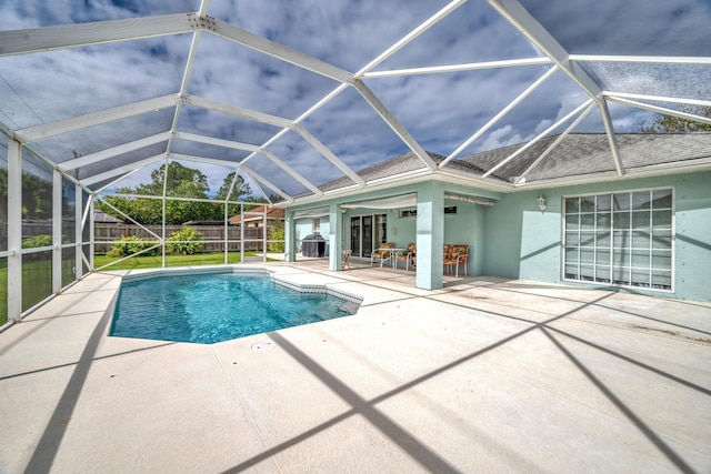 view of swimming pool with a lanai, fence, a fenced in pool, and a patio