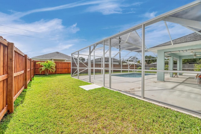 view of yard featuring a patio area, a fenced backyard, and a lanai