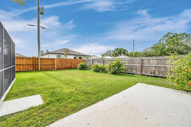 view of yard with a patio area and a fenced backyard