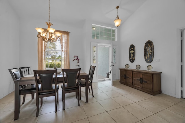 dining room with light tile patterned floors, baseboards, high vaulted ceiling, and a notable chandelier