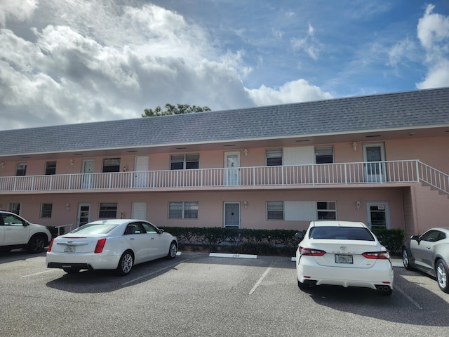 view of property featuring uncovered parking