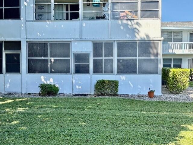 view of home's exterior with a lawn