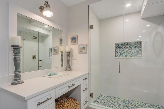 full bath featuring a shower stall, vanity, and recessed lighting