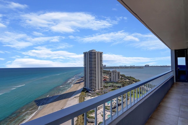 balcony featuring a city view and a water view