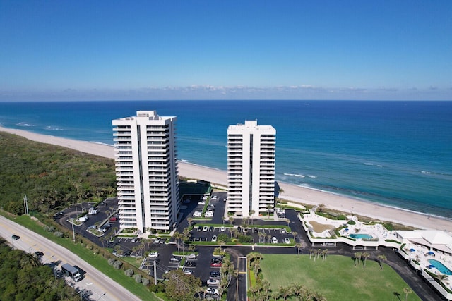 birds eye view of property with a water view and a view of the beach