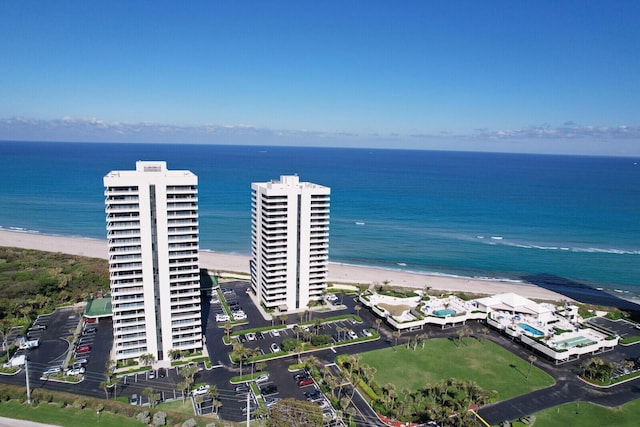 birds eye view of property featuring a view of the beach and a water view