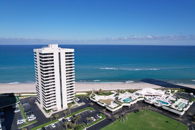 bird's eye view featuring a water view and a beach view