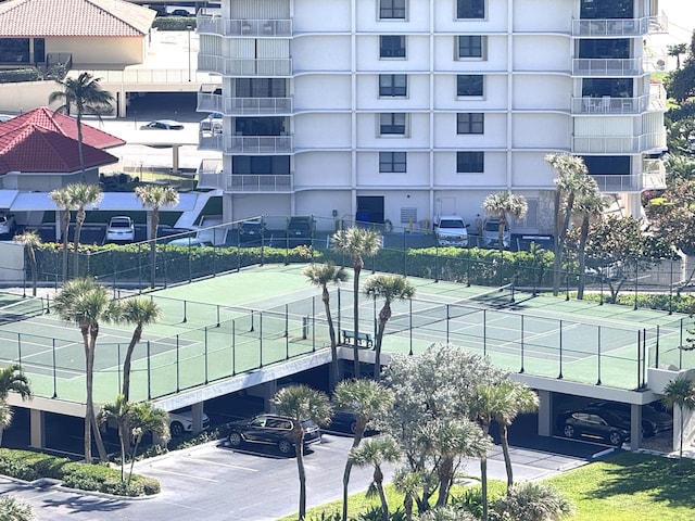 view of tennis court featuring fence