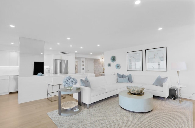 living room featuring light wood-style floors and recessed lighting