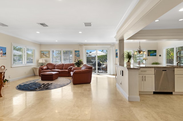 living area featuring a healthy amount of sunlight, visible vents, and ornamental molding