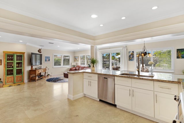 kitchen featuring dishwasher, a healthy amount of sunlight, open floor plan, and a sink