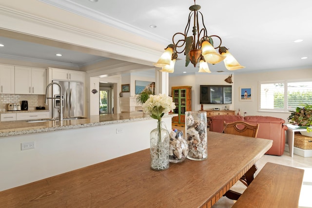 dining room with crown molding and recessed lighting