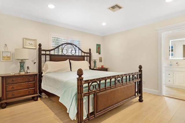 bedroom with visible vents, crown molding, light wood-type flooring, and baseboards