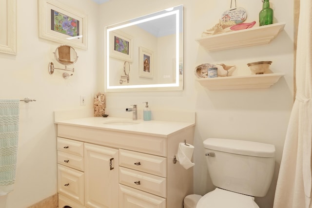 bathroom featuring toilet and vanity