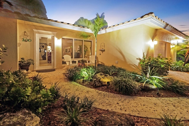 doorway to property with stucco siding