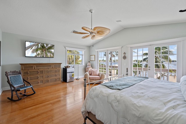 bedroom featuring french doors, light wood finished floors, visible vents, vaulted ceiling, and access to outside