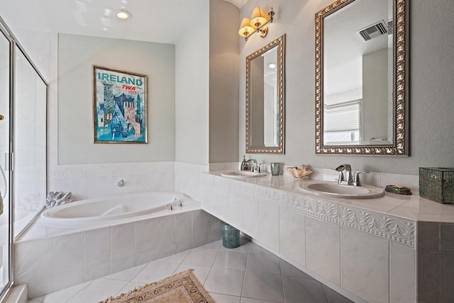 full bathroom featuring a garden tub, a sink, visible vents, and tile patterned floors