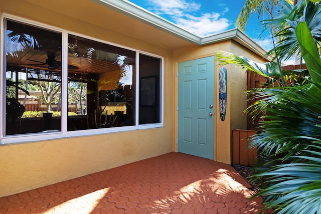 doorway to property with stucco siding