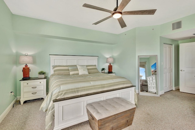 bedroom featuring baseboards, ceiling fan, visible vents, and light colored carpet