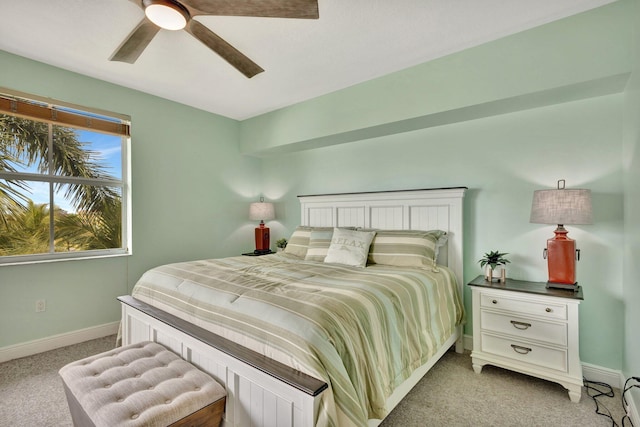 bedroom featuring light carpet, ceiling fan, and baseboards