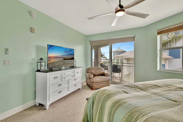 bedroom with baseboards, access to outside, multiple windows, and light colored carpet