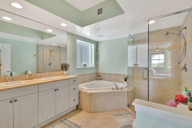 bathroom with a shower stall, a sink, and tile patterned floors