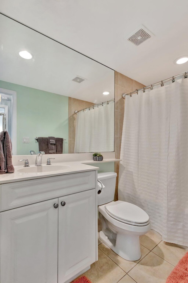 full bathroom with visible vents, vanity, toilet, and tile patterned floors