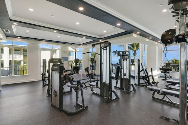 gym featuring recessed lighting, visible vents, a raised ceiling, and ornamental molding