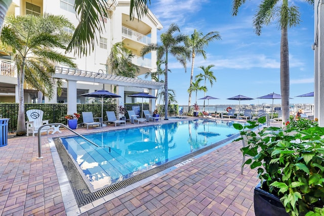 community pool featuring a patio area, fence, and a pergola