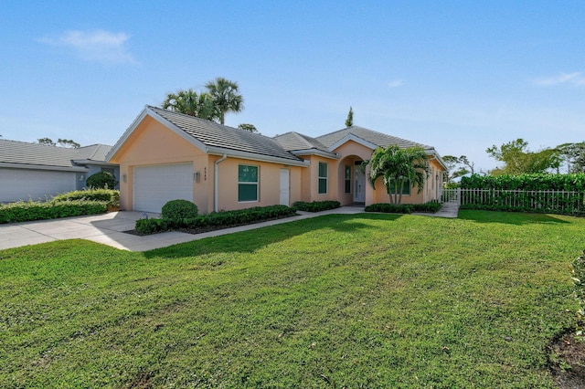 view of front facade with an attached garage, fence, driveway, stucco siding, and a front lawn