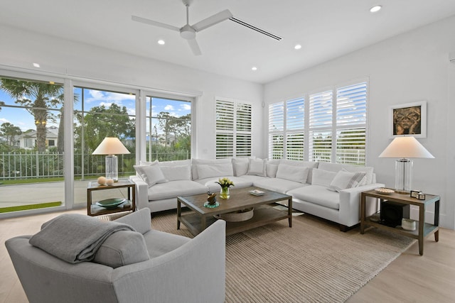 living area with ceiling fan, light wood-style floors, and recessed lighting