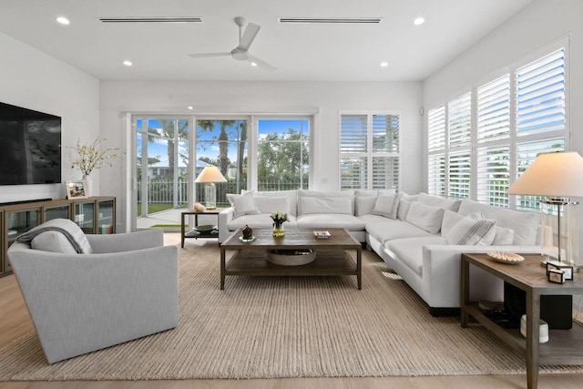 living room with ceiling fan, visible vents, and recessed lighting