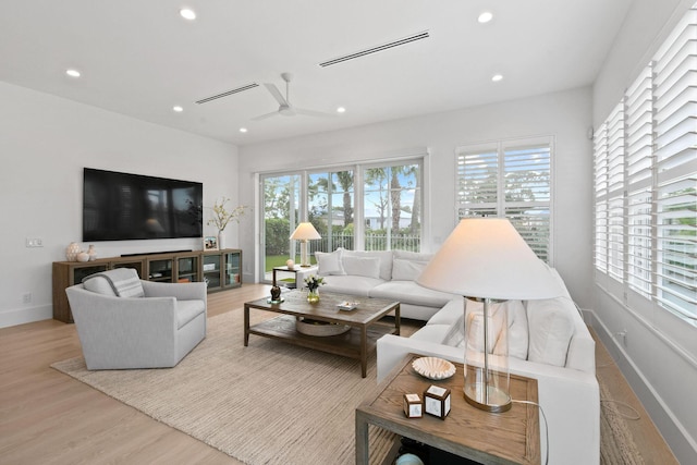 living room featuring visible vents, baseboards, a ceiling fan, wood finished floors, and recessed lighting