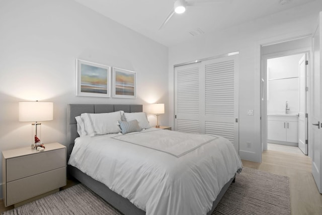 bedroom featuring a closet and light wood-style flooring