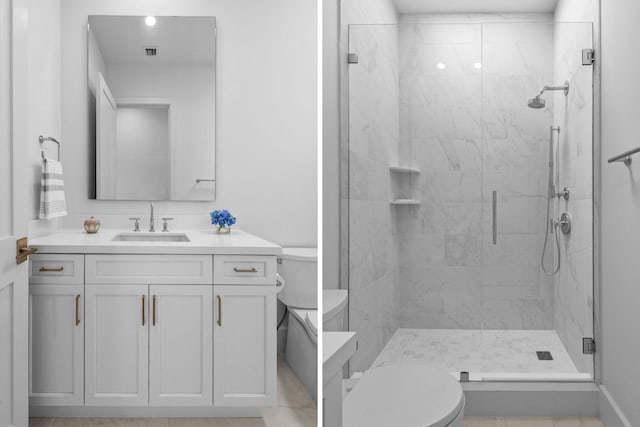 bathroom with visible vents, vanity, a shower stall, and toilet